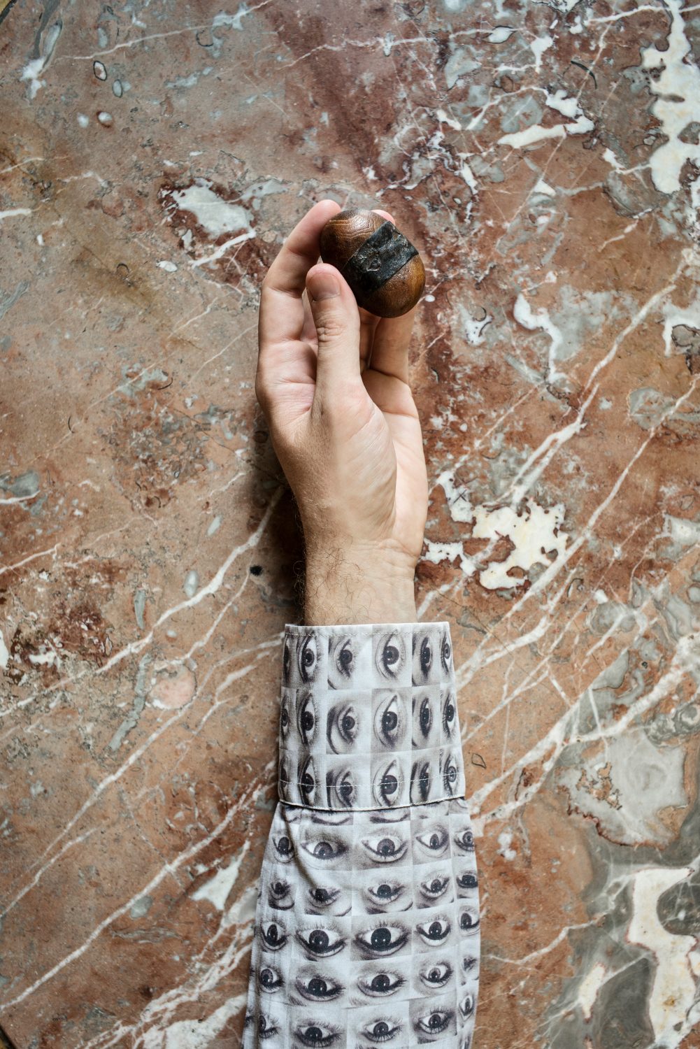 Thomas Hardwick, an Egyptologist, holds his lucky stone with ancient leather wrapped around it.
