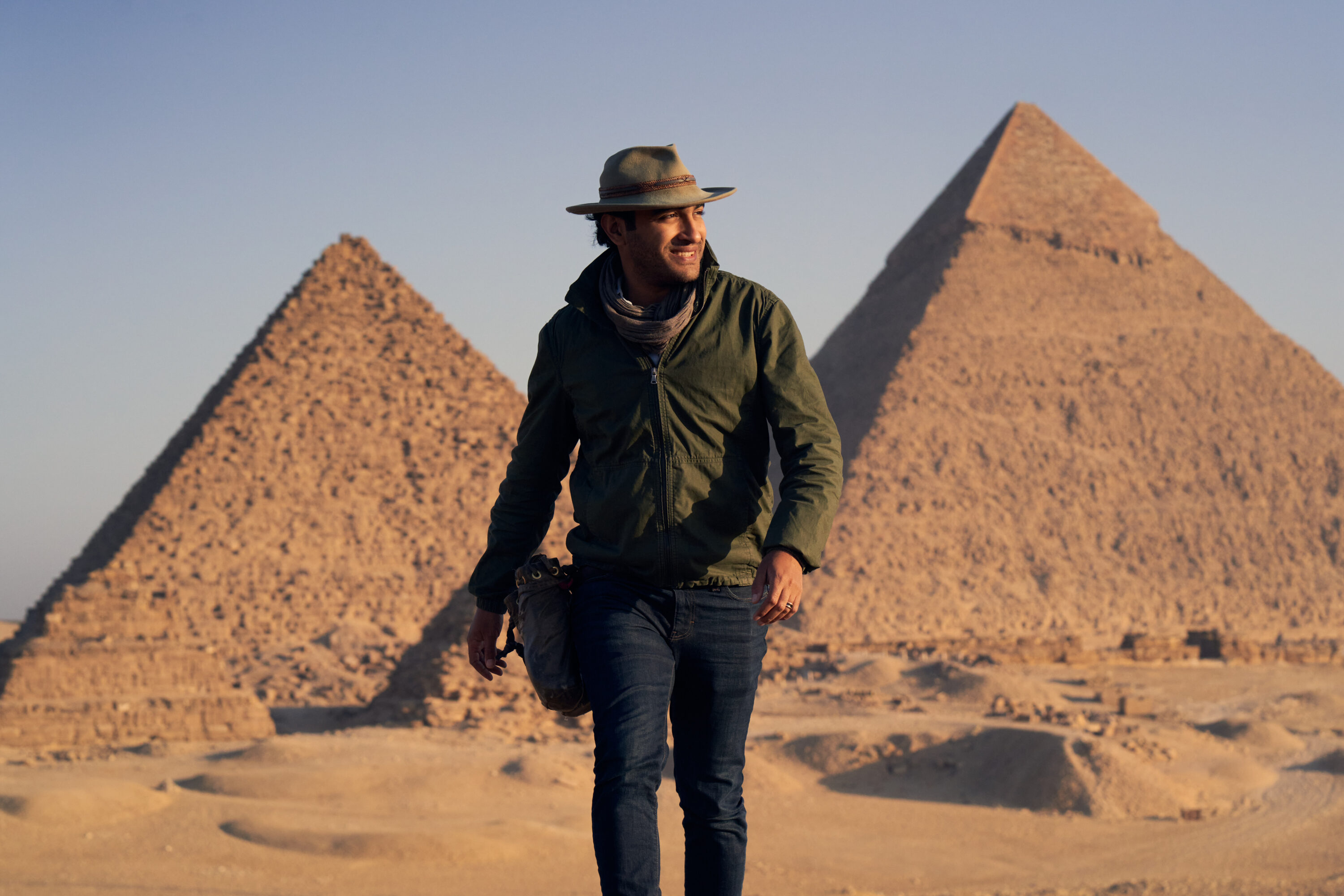 Adventure photographer walking near the pyramids in Egypt
