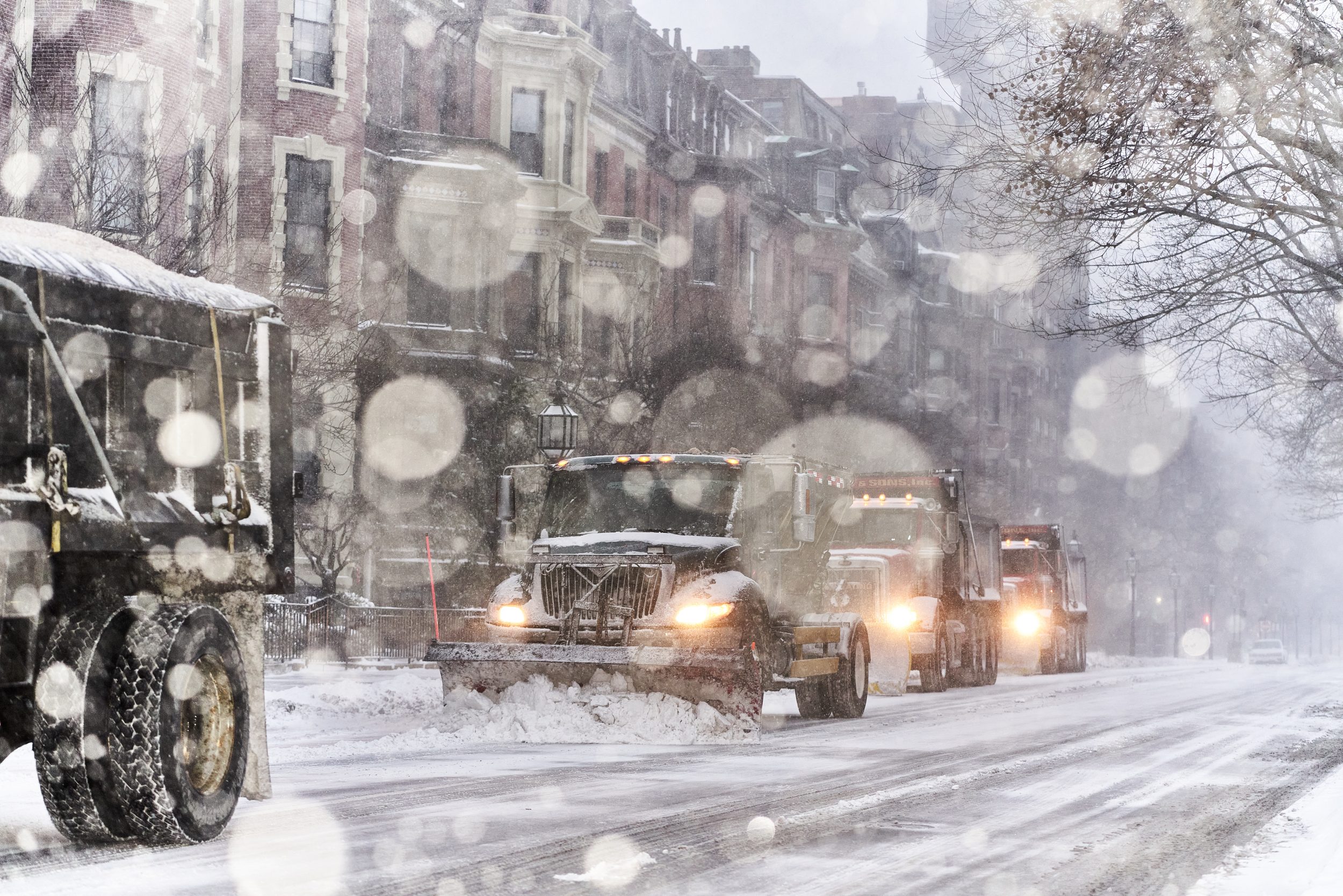 Trucks plow the early morning show in Back Bay 
