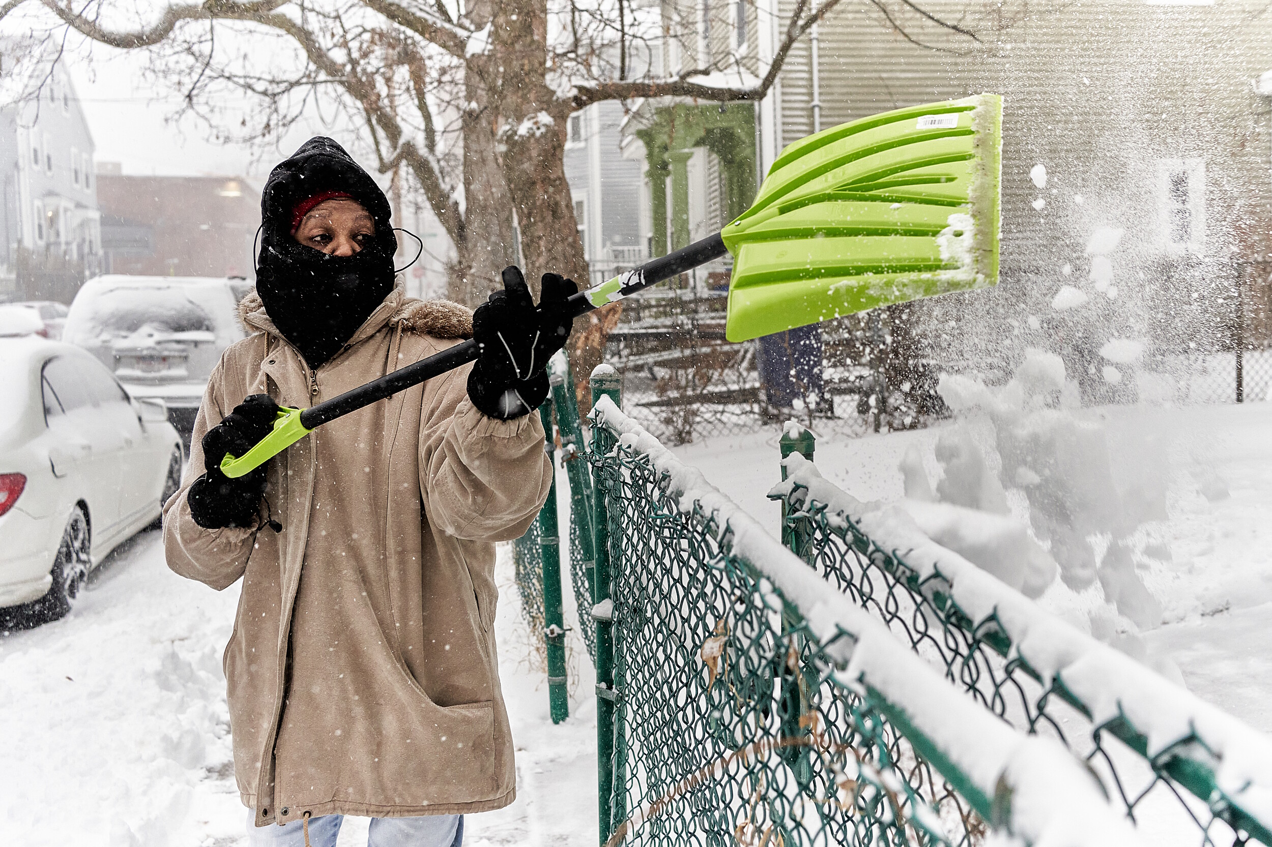 JoAnn Butler, 71, shovels the snow in front of her home.