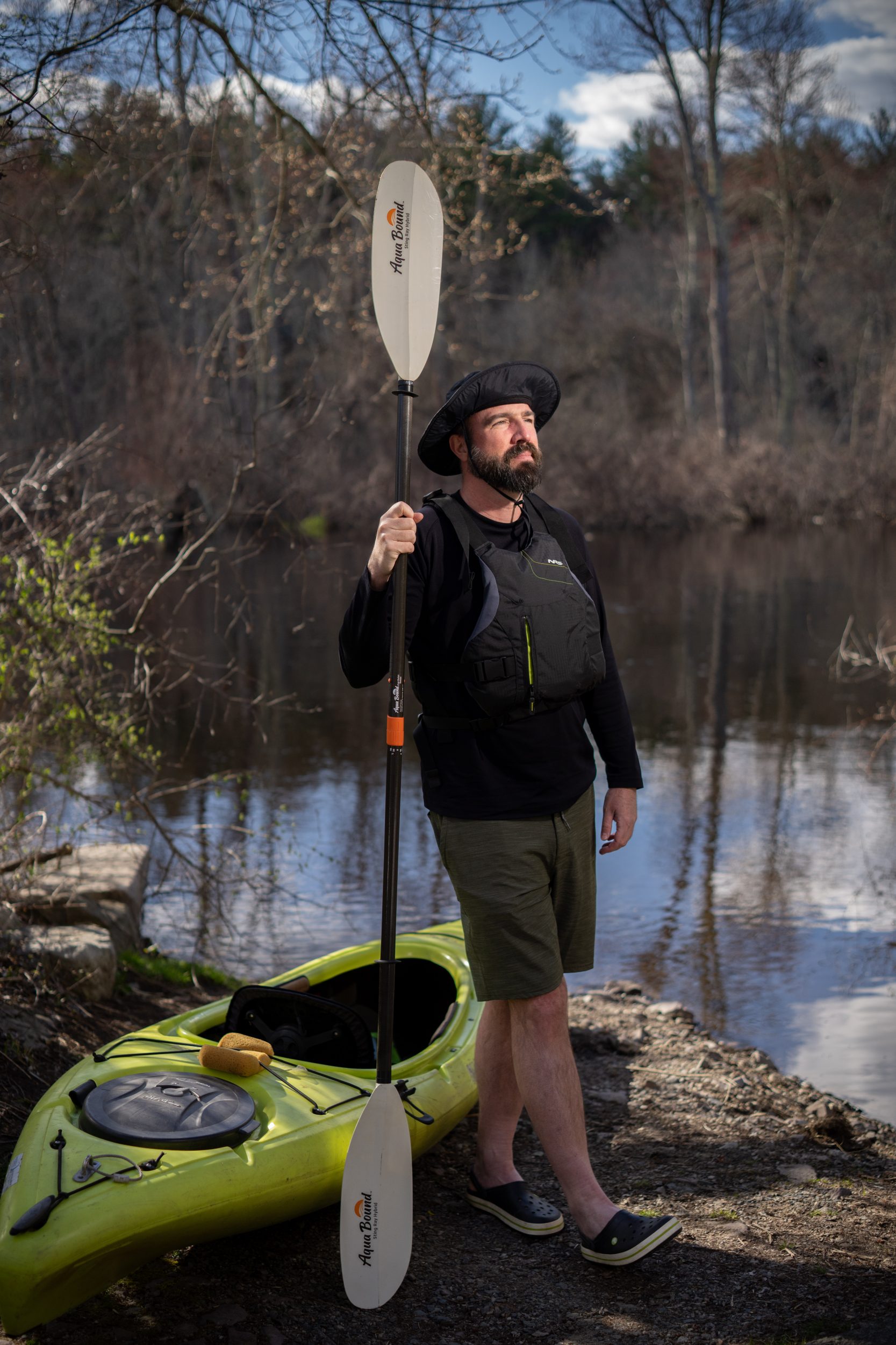 Portrait of Gerry Brown with his kayak, beside the Charles River.