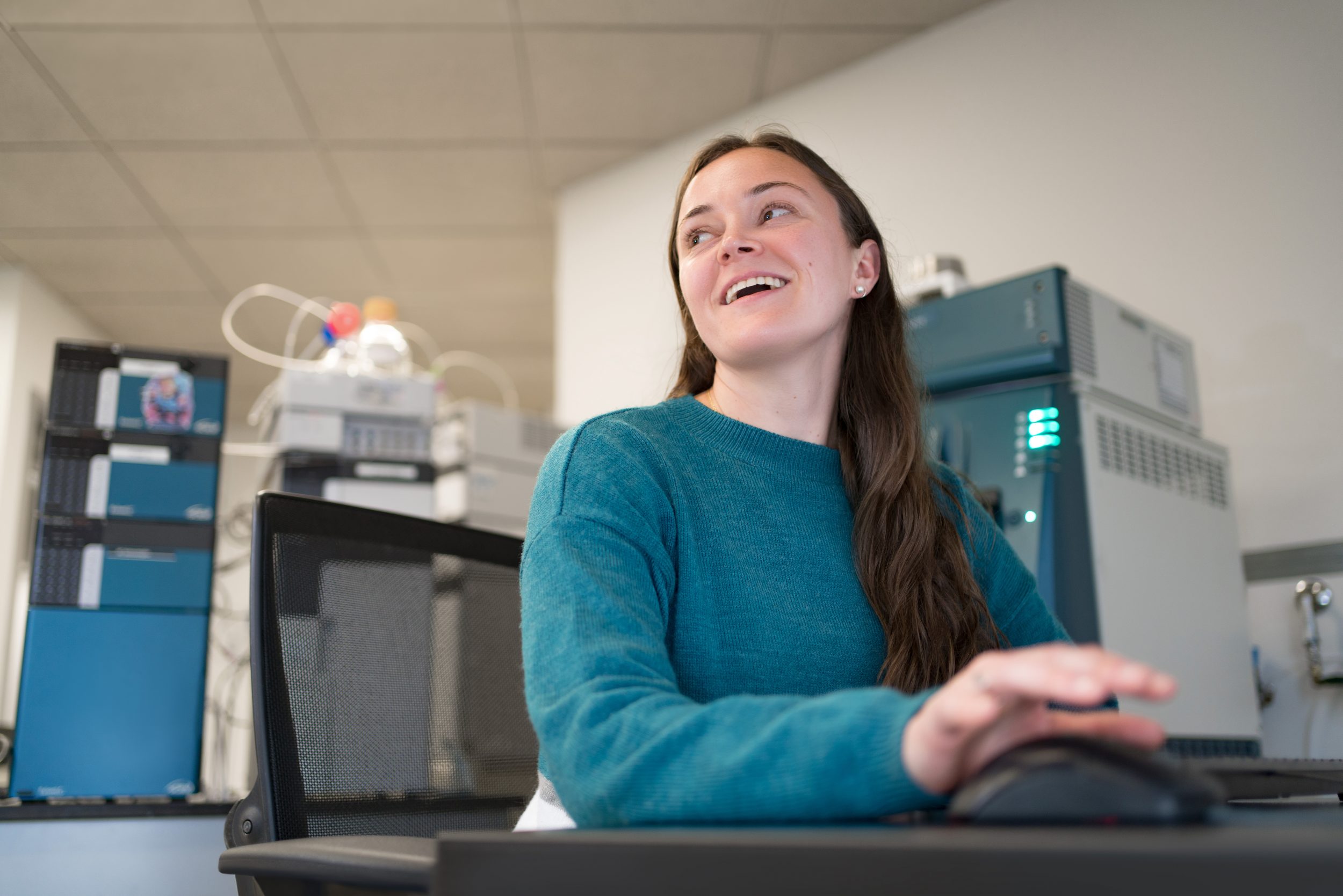 One of the researchers who helped develop mass spectrometers, capillary electrophoresis, and HPLC products sits before the latest machine.