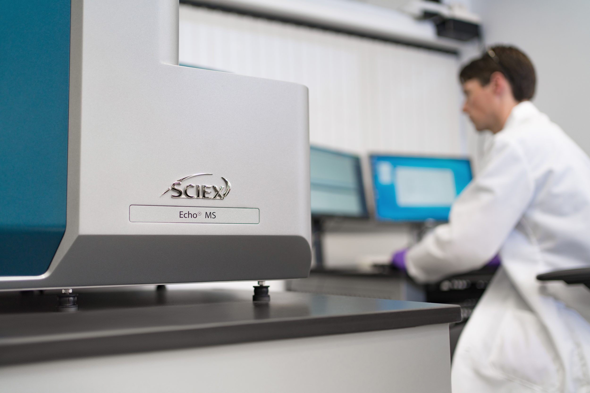 One of the researchers who helped develop mass spectrometers, capillary electrophoresis, and HPLC products sits before the latest machine.