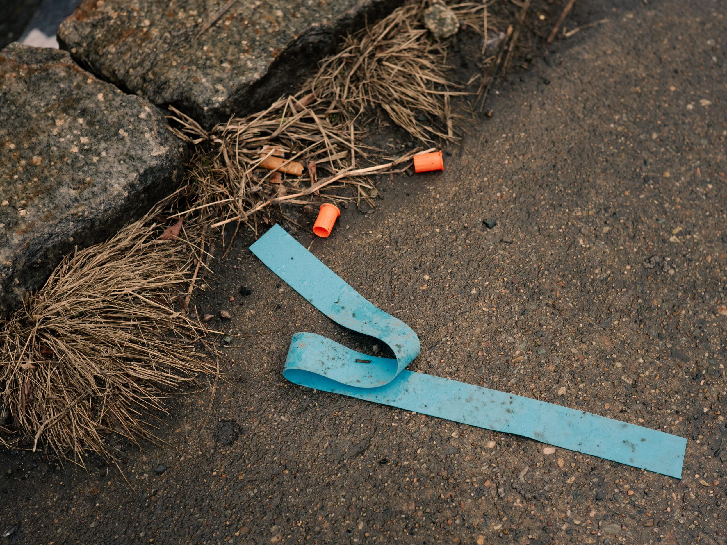 A discarded tourniquet and syringe caps lie in the gutter on Bradston Street near Mass and Cass in Boston A discarded tourniquet and syringe caps lie in the gutter on Bradston Street near Mass and Cass in Boston
