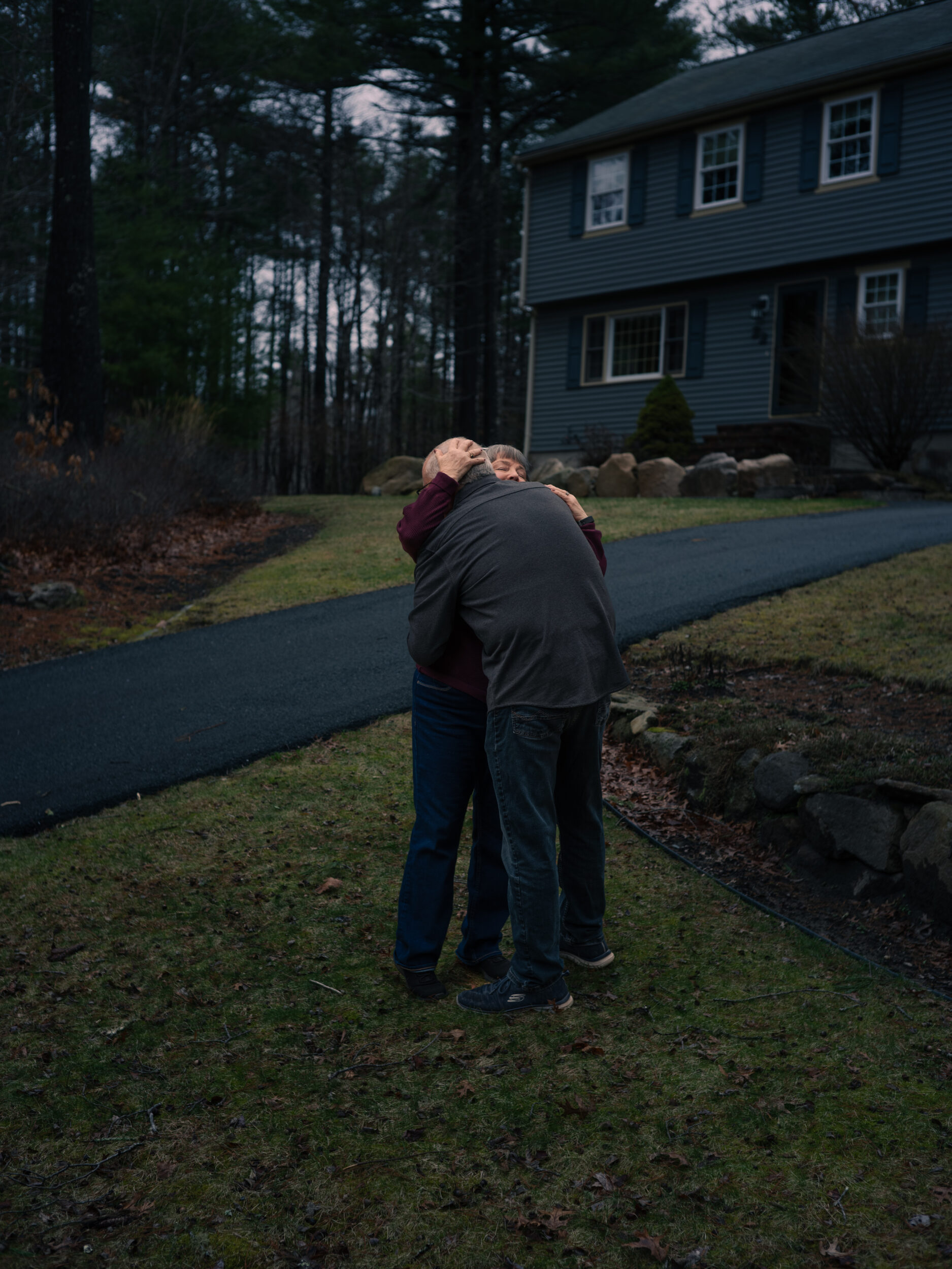 Jan and Chris Hogan embrace outside their home in Wareham as they wait for their missing son Bryan to return