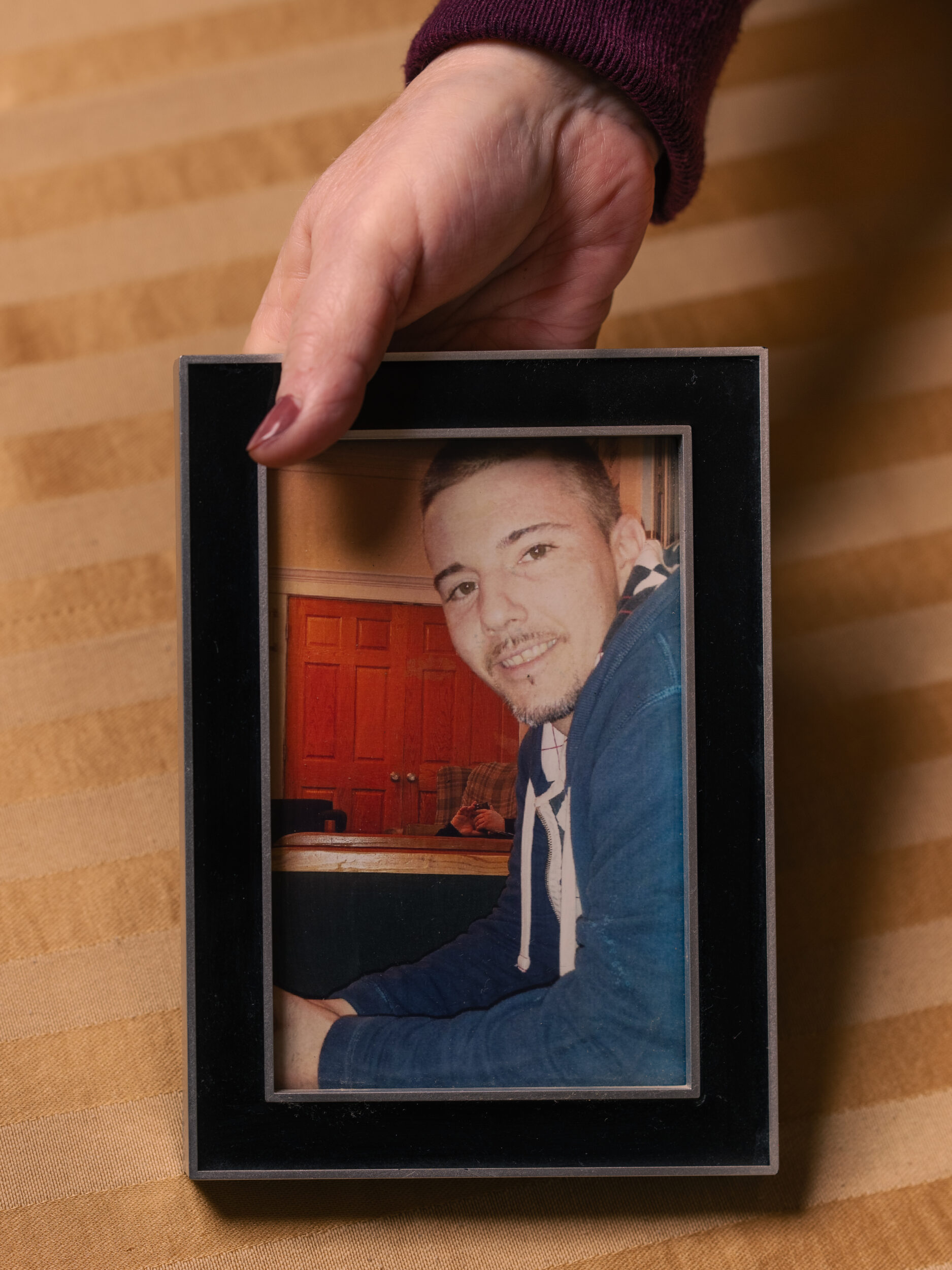 Jan Hogan holds a framed photograph of her son Bryan Jan Hogan holds a framed photograph of her son Bryan
