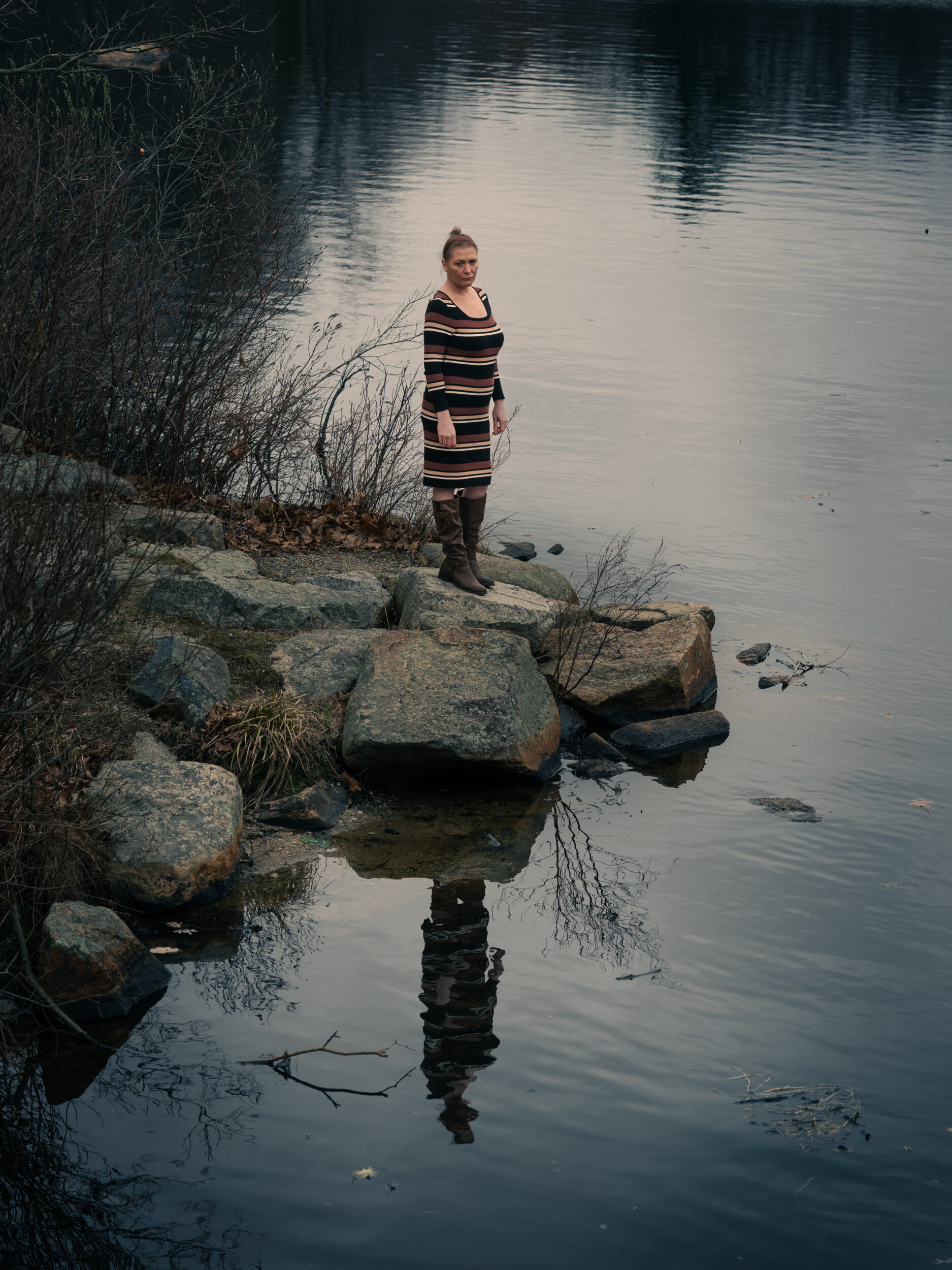 Courtney Flynn stands on rocks at the edge of a pond at Pond Meadow in Braintree