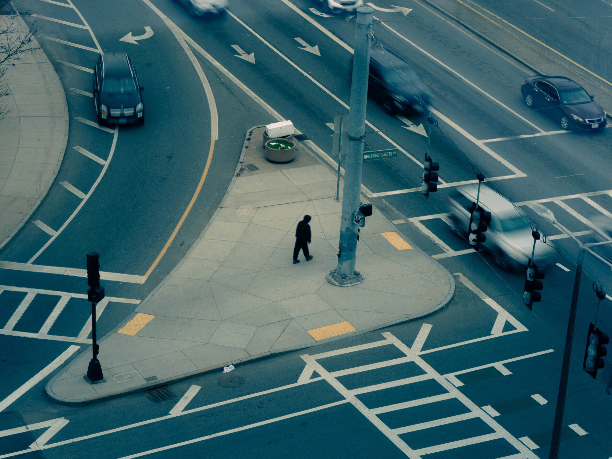 A person walks across the traffic island at the intersection of Massachusetts Avenue and Melnea Cass Boulevard in Boston A person walks across the traffic island at the intersection of Massachusetts Avenue and Melnea Cass Boulevard in Boston