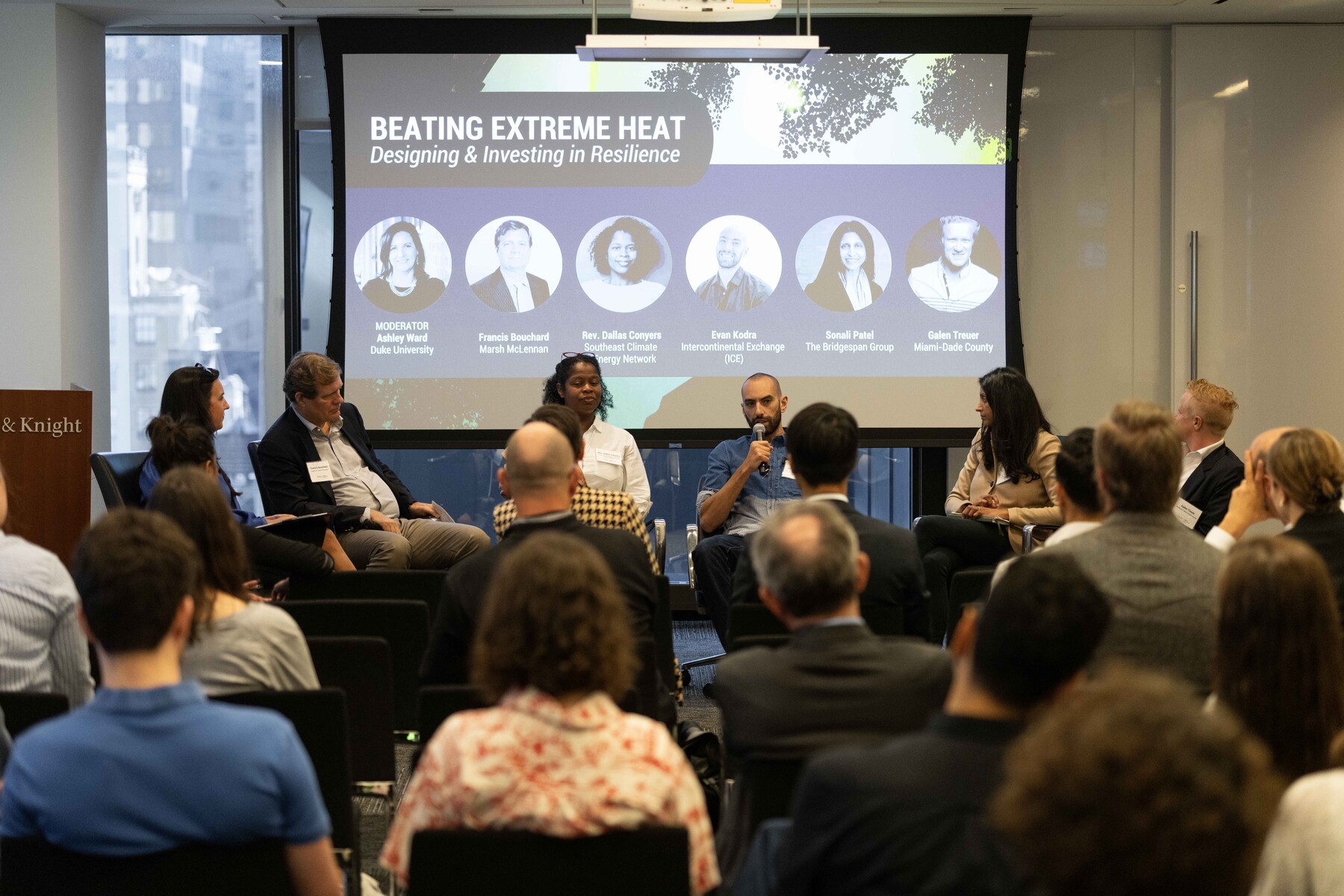 Panelists discuss extreme heat before a seated audience.