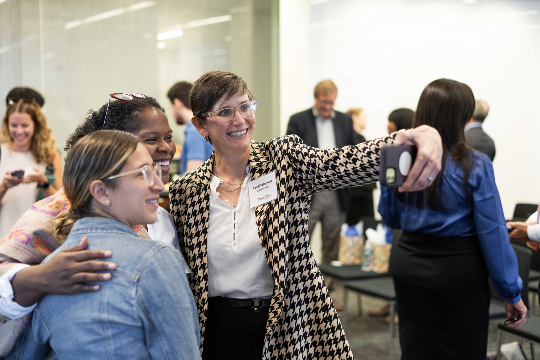 Three attendees gather for a selfie after a session.